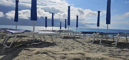 Spotorno, Ligurian Riviera in summer. A bathing establishment is a tourist facility located near a beach, equipped with rooms and equipment that offer services and hospitality to bathers for bathing. photo