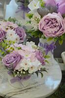 Decorative compositions with bouquets of flowers in vases in a flower shop. Interior artificial flowers. photo