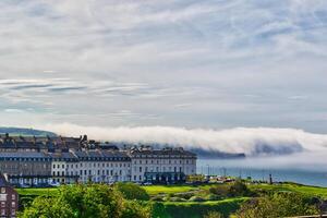 Coastal town with fog rolling in from the sea in Whitby, North Yorkshire photo