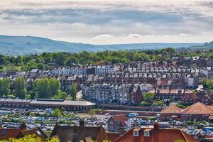Panoramic view of residential area with parking lot and hills in Whitby, North Yorkshire photo