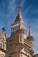 Gothic Tower Against Blue Sky in Harrogate photo
