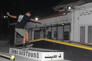 Indonesia - Medan 01 Agustus 2023 an asian man on a skateboard doing tricks on a box photo