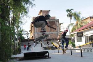 Indonesia - Medan 01 August 2023 an asian man doing skateboard tricks on a ramp photo