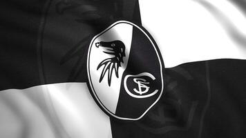 Flag with emblem of German football team. Motion. Beautifully waving flag with logo of football team. Flag of Freiburg football team video