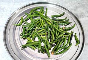 Close up top view of freshly harvested green chillies photo