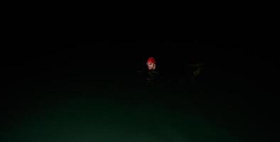 Authentic triathlete swimmer having a break during hard training on night photo