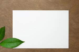 Beautiful Mockup Paper on Wooden Background Combined with Leaves, Creating a Charming and Natural Setting for Creative Designs and Artistic Presentations photo