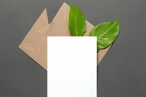 Beautiful Mockup Paper on Wooden Background Combined with Leaves, Creating a Charming and Natural Setting for Creative Designs and Artistic Presentations photo