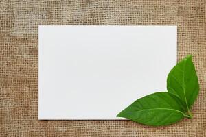 Beautiful Mockup Paper on Wooden Background Combined with Leaves, Creating a Charming and Natural Setting for Creative Designs and Artistic Presentations photo