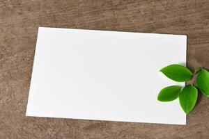 Beautiful Mockup Paper on Wooden Background Combined with Leaves, Creating a Charming and Natural Setting for Creative Designs and Artistic Presentations photo