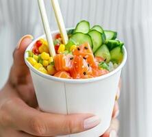 Person Holding Bowl of Food With Chopsticks photo