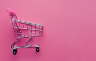 Shopping Cart on Pink Background photo