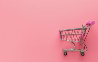 Shopping Cart on Pink Background photo