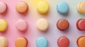 Overhead view of a colorful assortment of macarons on a pastel gradient background photo
