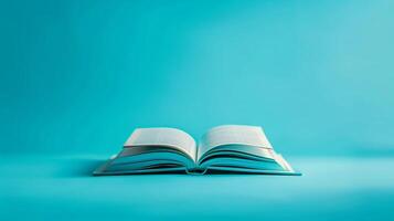 An open hardcover book on a calming teal to indigo gradient background photo