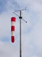 Windsock floating in the wind indicating wind strength and direction. photo