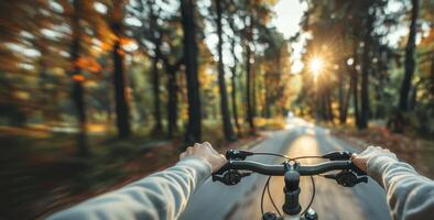 Bicycle Riding Photo. Close up of Hands on Bicycle Handlebar in the Forest. Blurred Forest Background. Sunny Day. High Speed Bicycle Riding Background. photo