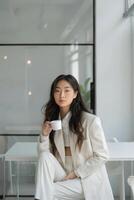 Woman Sitting on Floor Holding Cup photo