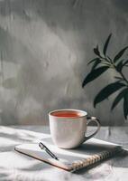 Cup of Tea Next to Book on Saucer photo