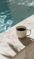 Cup of Coffee Next to Pool Ledge photo