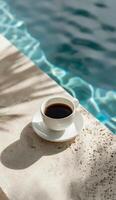 Cup of Coffee Next to Pool Ledge photo