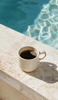 Cup of Coffee Next to Pool Ledge photo