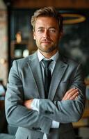 Businessman in Suit and Tie Standing With Arms Crossed photo
