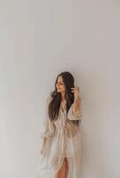 Woman Standing in Front of White Wall photo