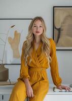 Woman in Yellow Jumpsuit Sitting at Desk photo