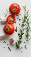 Tomatoes, Garlic, and Herbs Arranged on a White Surface photo