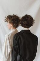Two People Standing in Front of a White Backdrop photo