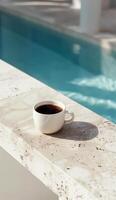 Cup of Coffee Next to Pool Ledge photo