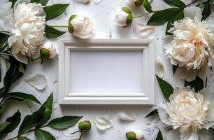 White Frame Surrounded by Flowers and Leaves photo
