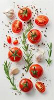 Tomatoes, Garlic, and Herbs Arranged on a White Surface photo