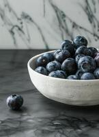 White Bowl Filled With Blueberries on Table photo