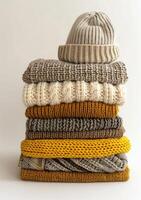 Stack of Knitted Sweaters and Hats photo