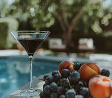 Glass of Wine Next to Bunch of Fruit photo