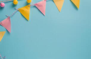 Blue Background With Yellow and Pink Paper Buntings photo