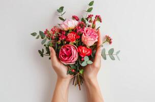 Person Holding Bunch of Red Flowers photo