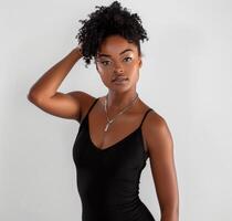 Woman in Black Bodysuit Posing for a Picture photo