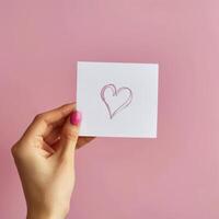 Person Holding Card With Heart Drawing photo