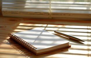 Notebook and Pen on Wooden Table photo