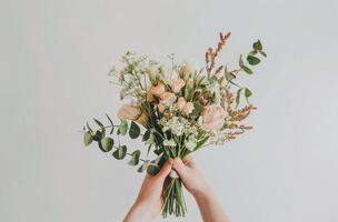 Person Holding Bunch of Flowers photo