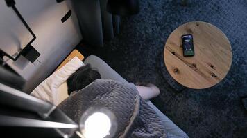 Overhead view of a man sleeping with a phone ringing on the nightstand. video