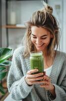 Woman Holding Drink and Looking at Cell Phone photo