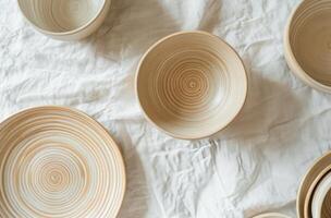Group of Bowls on White Sheet photo
