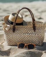 Hat, Sunglasses, and Straw Bag on the Beach photo