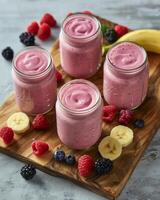Three Jars of Smoothie With Bananas and Raspberries photo