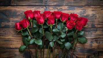 A Bunch of Red Roses on a Wooden Table photo