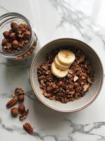 Healthy Breakfast Bowl With Granola, Bananas, and Nuts photo
